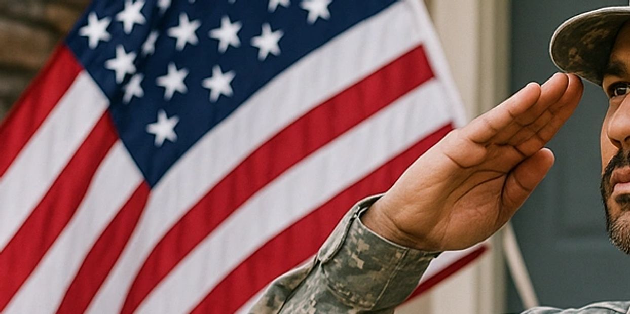 veteran standing in front of a home saluting u.s.a. flag
