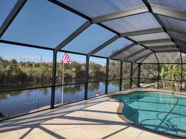 A mansard roof enclosure offers a spacious and breezy ambiance for your pool.