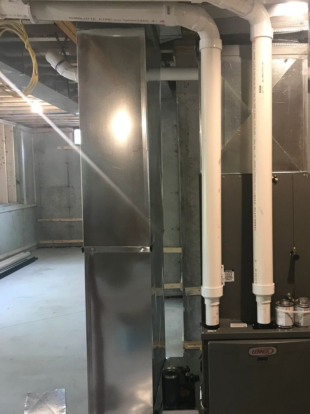 Newly installed furnace system in unfinished basement.
