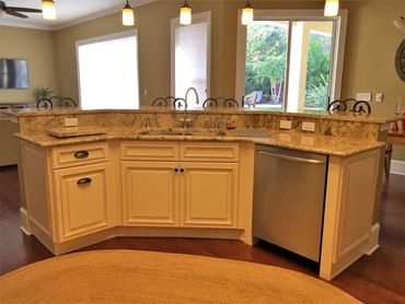 Kitchen remodel with raised bar island, granite countertops, and custom cabinetry.