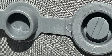 A close-up look at the Arto Pillow- Inflatable's inflation and deflation valve.