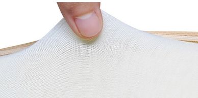 A finger pulling against the Arto Pillow - Memory Foam inner cotton cover.