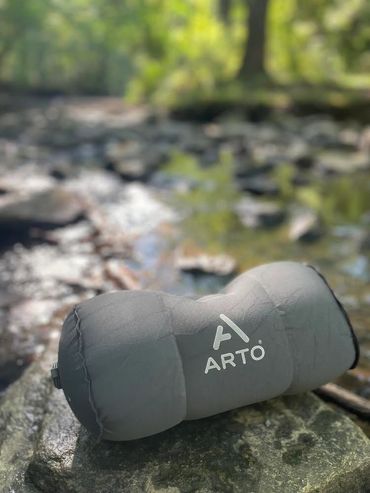Arto Pillow - Inflatable sitting on a rock, in the middle of a forest.