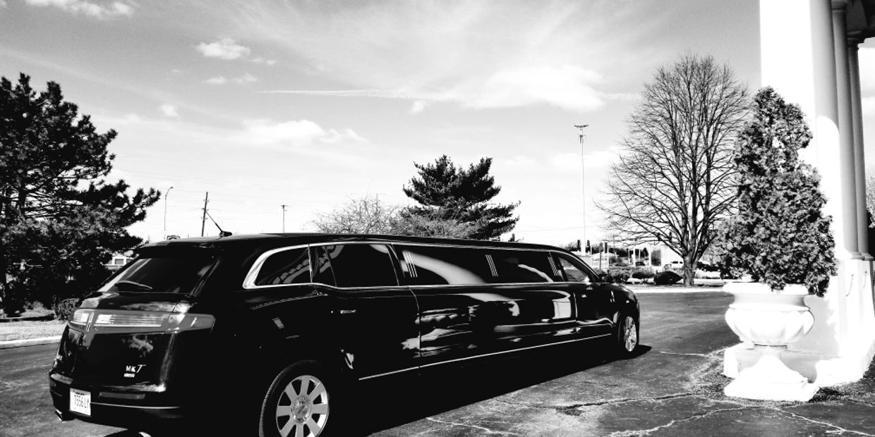 A black-and-white photo of a limousine