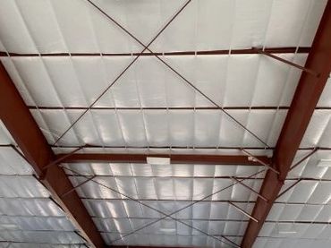 Photo of metal building ceiling with RB Warehouse Double Bubble Foil/White insulation.