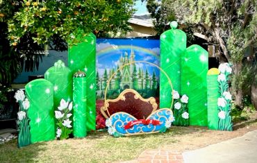 Festive St. Patrick's Day themed outdoor decoration with rainbow and castle.