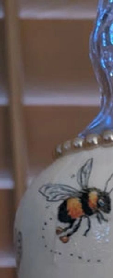 Up-cycled bottle with paint and decoupaged napkins