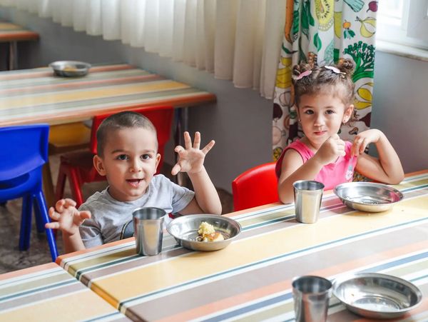 Toddlers sitting at a classroom table