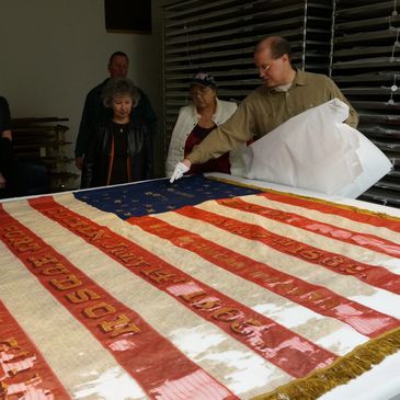 Matt VanAcker, Co-Chair of "Save the Flags" shows our group the flag of the 6th Michigan Infantry.