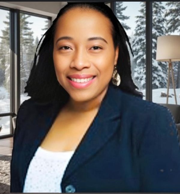 Smiling woman in business attire with snowy forest background.