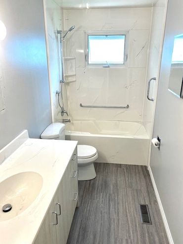 complete bathroom renovation, new flooring, toilet, vanity, vanity top, cultured marble tub and sur