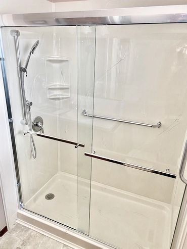 Bathroom renovation resulting in a walk in cultured marble shower base and panels with glass bypass