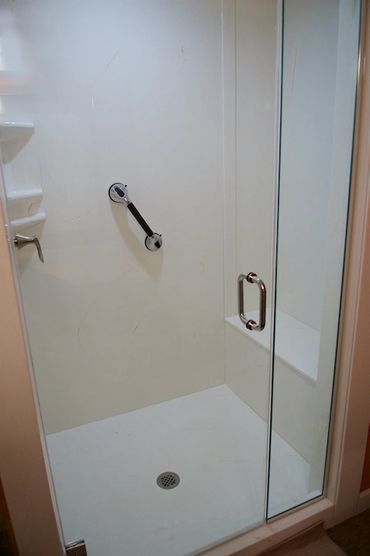 Bathroom renovation with a custom cultured marble shower and bench