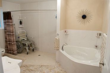 Wheelchair accessible cultured marble shower with custom base and ramp and cultured marble panels