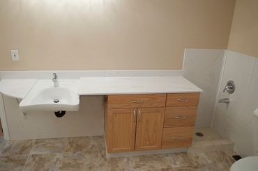 Wheelchair accessible vanity top an mop centre
