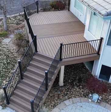 Finished custom composite deck with steel railing and outdoor kitchen in Parker Co