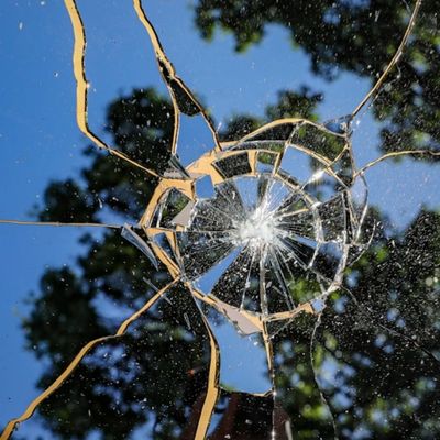 Shattered mirror reflecting blue sky and trees | Safe Harbor Counseling | Symbol of trauma