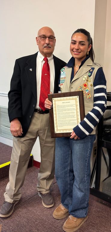 Samantha and the Mayor of Harrison holding the signed sustainability proclamation