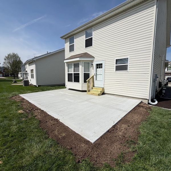Concrete backyard patio, with new treated steps.
