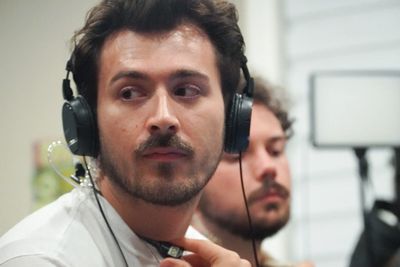 Man wearing headphones and holding a microphone.