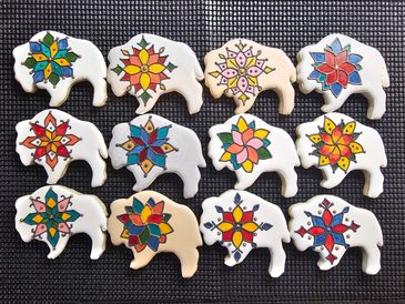 Elephant-shaped cookies decorated with colorful floral designs.