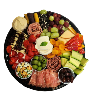 A platter of meat cheese fruits and hummus and veggies