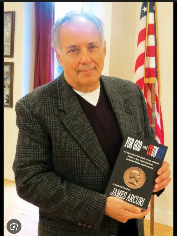 Man holding a book titled 'For God and Country' by James Arcuri.