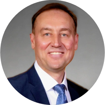 Smiling man in a suit and tie.