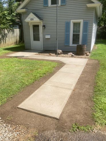 New concrete sidewalk after landscaped.