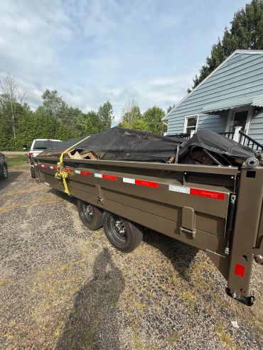 Dump trailer loaded with debris from shed demo