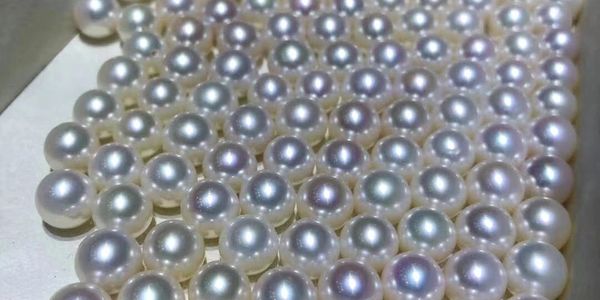 A collection of lustrous white pearls in a box.