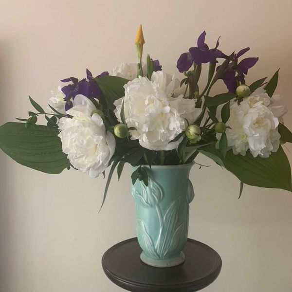 This is a custom arrangement in a client's vase featuring peonies, which are usually available in Ma