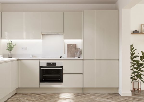 Modern beige kitchen with built-in oven and plants.