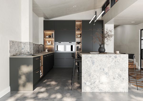 Modern kitchen with dark cabinets and stone island.