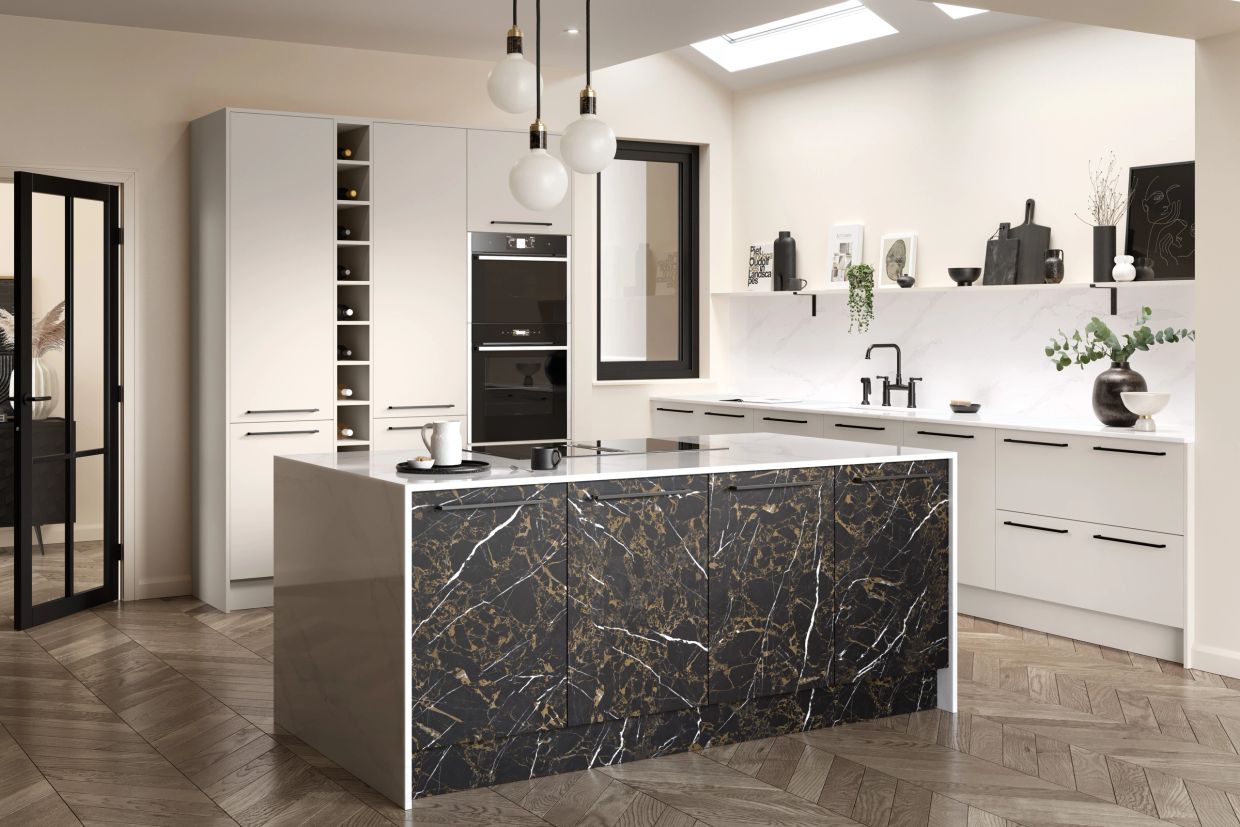 Modern kitchen with marble island and white cabinets.