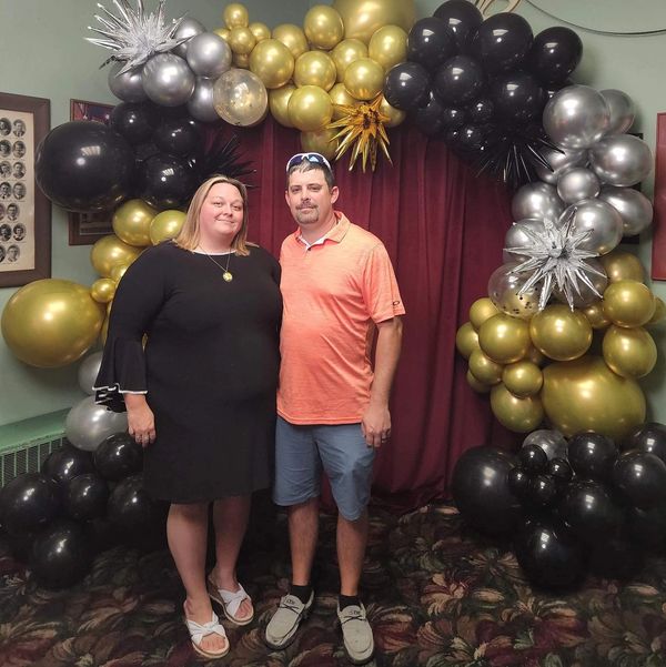 Brad Whitman, owner of Whitman Roofing and Restoration, standing with his wife.