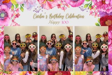 Group of friends wearing fun sunglasses at Cecilia's 100th birthday celebration.