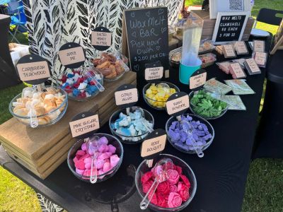 Various colorful wax melts on display at a stand.