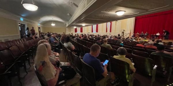 Audience attending a panel discussion in an auditorium.