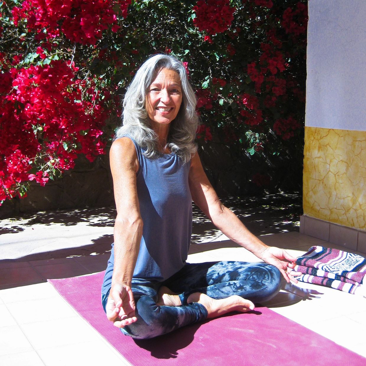 Cherie sitting in simple cross legged, erect spine, white haired and smiling!