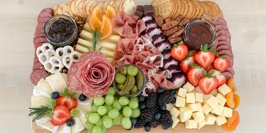 Charcuterie board. fruits. Gourmet cheese. Cured meats. Jam. Jelly. Crackers