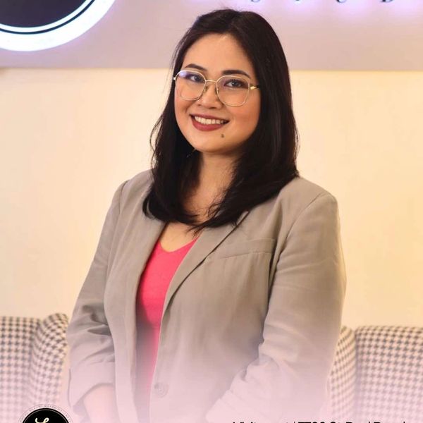 Professional woman smiling at La Belle Wellness Studio in Makati.