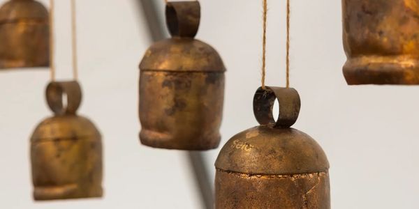 Old brass bells hanging by strings.