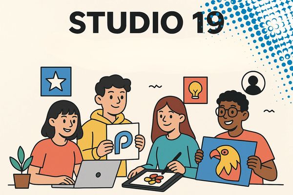 Four people collaborating creatively in Studio 19 with digital and printed artwork.