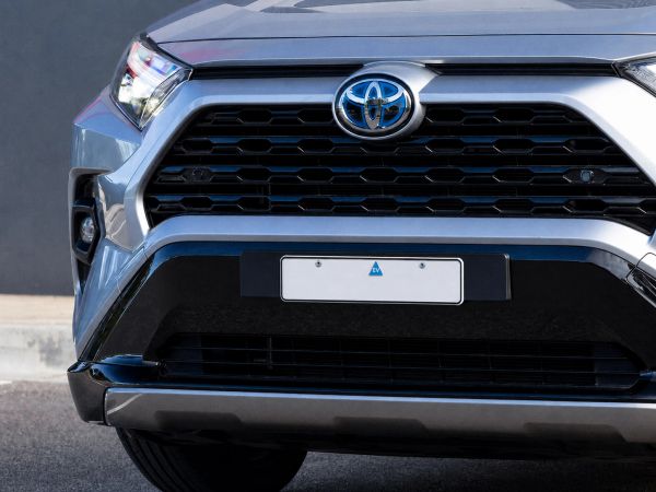 Front grille of a Toyota vehicle with a license plate.