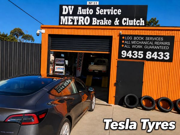 Tesla parked outside DV Auto Service brake and clutch shop.