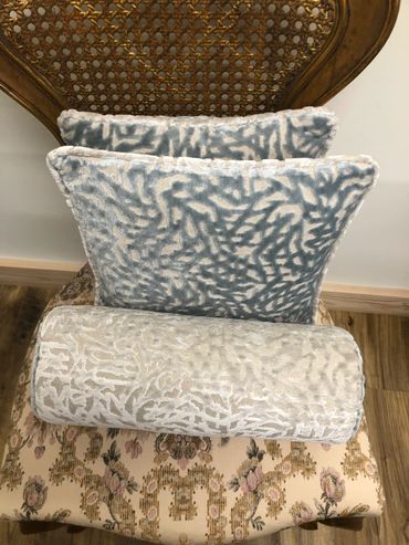 Two matching cushions and small bolster
