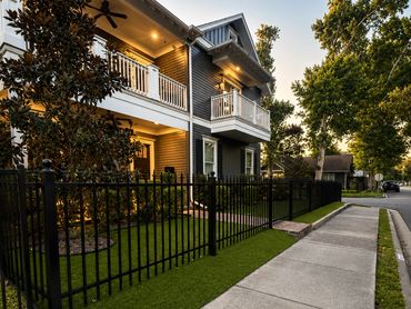 Black ornamental metal fence installation at a Houston Heights home