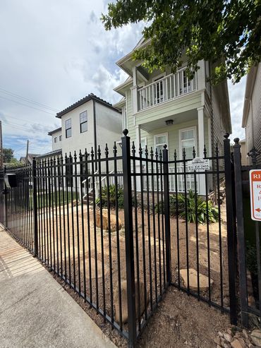 Custom black metal fence and gate installation in Houston Heights