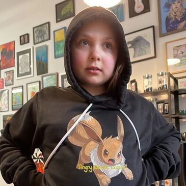 Evie Davis wearing a black hoodie with the Pokémon Eevee.